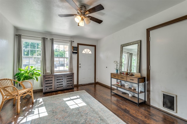 foyer with baseboards, ceiling fan, and wood finished floors
