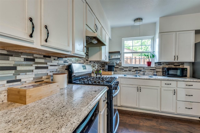 kitchen featuring black microwave, dishwashing machine, stainless steel gas range oven, tasteful backsplash, and a sink