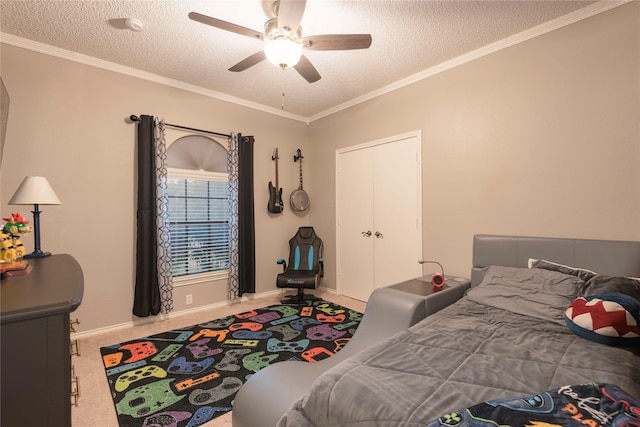 bedroom featuring crown molding, carpet floors, a textured ceiling, a ceiling fan, and baseboards