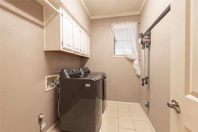 laundry area with crown molding, cabinet space, baseboards, tile patterned floors, and washer and clothes dryer