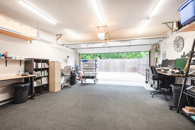 carpeted home office with a textured ceiling and a garage