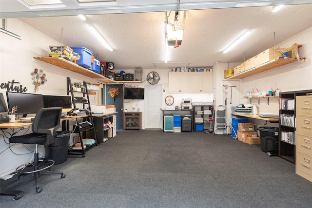 carpeted home office with a textured ceiling and a garage