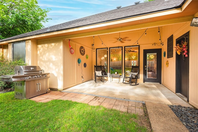 rear view of property with a ceiling fan and a patio area