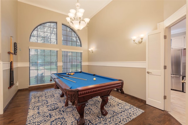 recreation room with crown molding, an inviting chandelier, billiards, and wood finished floors