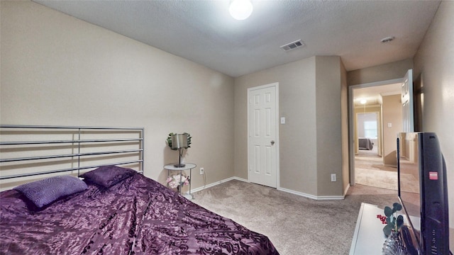 bedroom with visible vents, carpet flooring, and baseboards