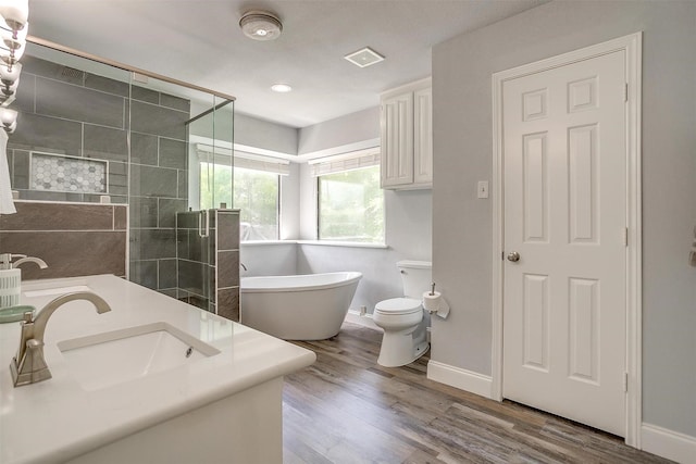 full bath featuring a sink, a freestanding tub, baseboards, and a stall shower