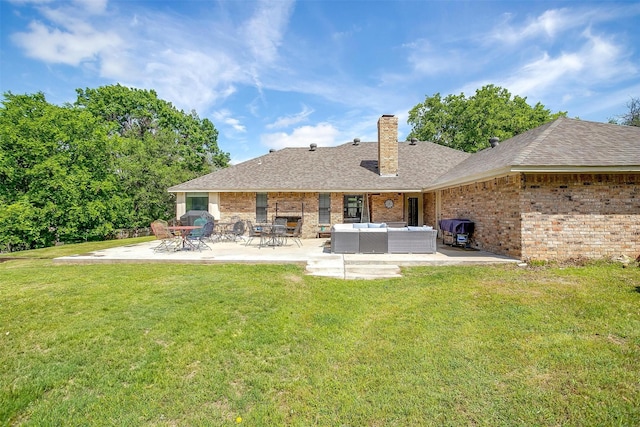 back of property with an outdoor hangout area, a patio, a yard, and brick siding