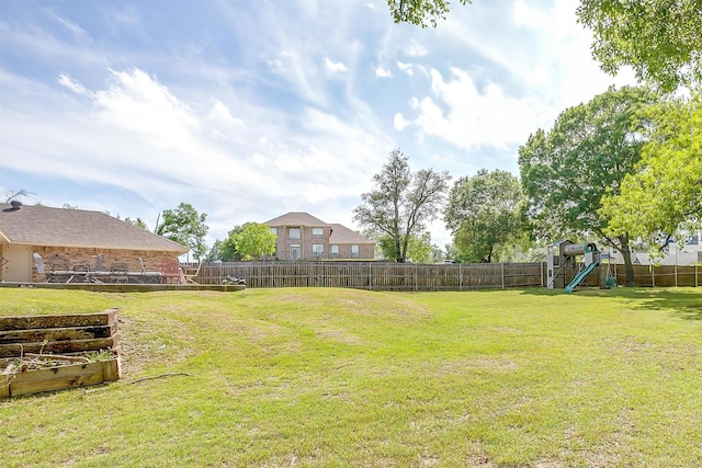 view of yard featuring a playground and a fenced backyard