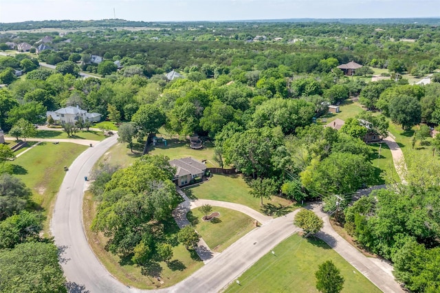 birds eye view of property featuring a forest view
