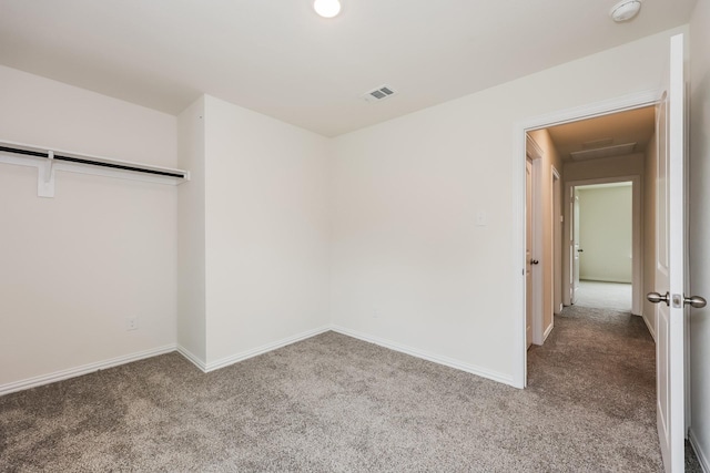 unfurnished bedroom with carpet floors, baseboards, and visible vents