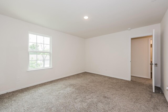 carpeted spare room with baseboards and recessed lighting
