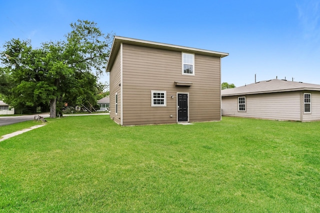 rear view of house with a yard