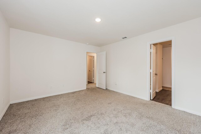 unfurnished room featuring baseboards, carpet flooring, recessed lighting, and visible vents