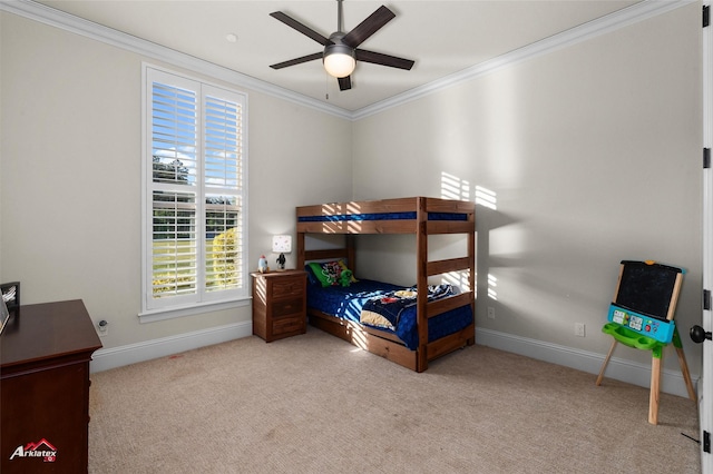 carpeted bedroom with baseboards, ornamental molding, a ceiling fan, and multiple windows