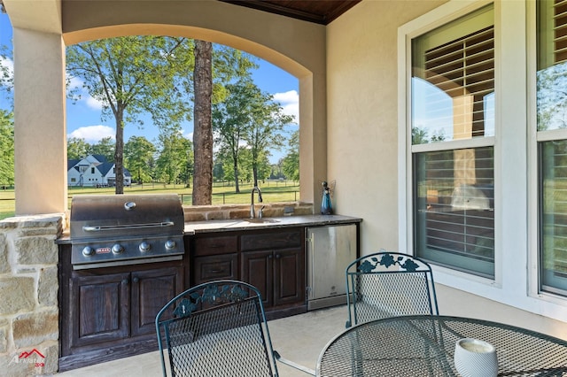 view of patio / terrace featuring outdoor dining space, a sink, grilling area, and an outdoor kitchen
