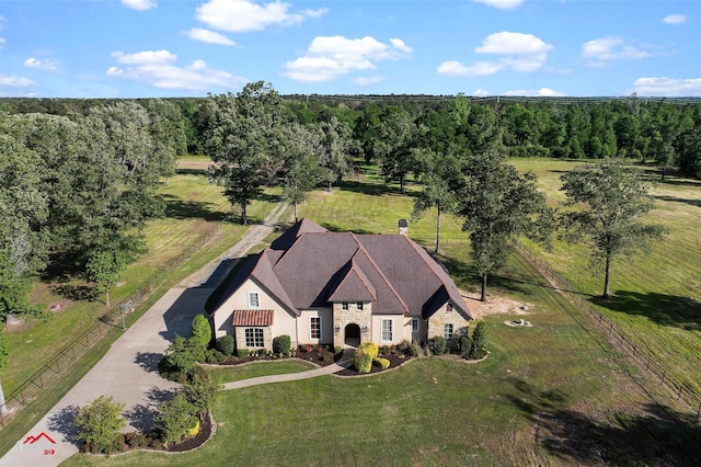 drone / aerial view featuring a wooded view