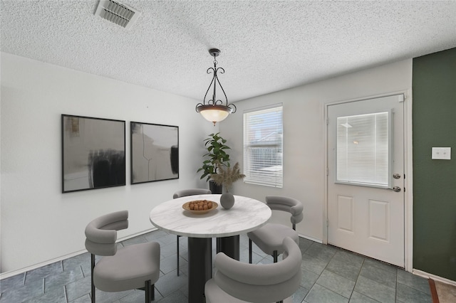 2011 Kalgary Ln, Grand Prairie, TX 75052 - dining room with a textured ceiling and baseboards