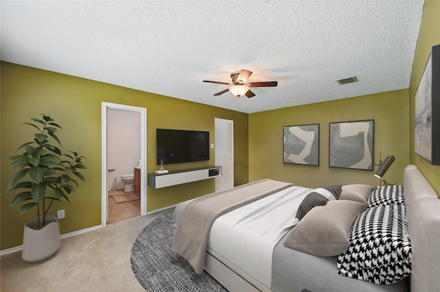 2011 Kalgary Ln, Grand Prairie, TX 75052 - bedroom with light colored carpet, baseboards, a textured ceiling, a ceiling fan, and ensuite bath