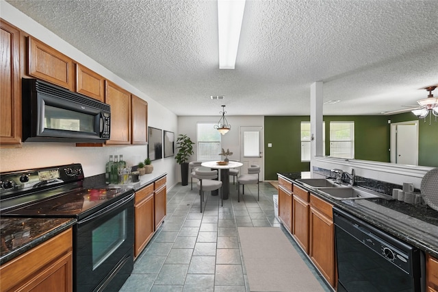 2011 Kalgary Ln, Grand Prairie, TX 75052 - kitchen with black appliances, a sink, brown cabinetry, a textured ceiling, and a ceiling fan