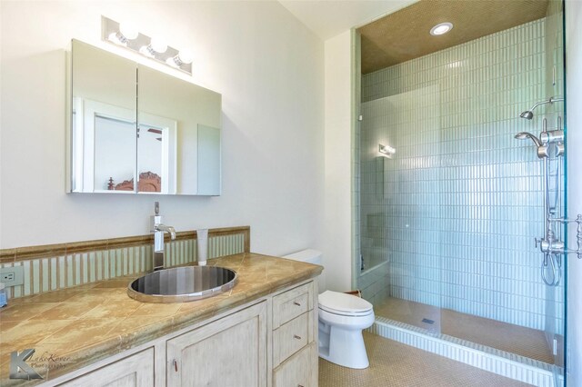 990 County Road 621, Tuscola, TX 79562 - full bathroom featuring toilet, tile patterned floors, tiled shower, and vanity