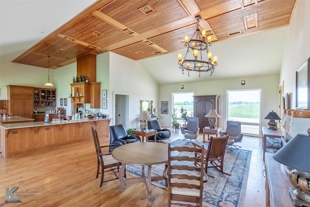 990 County Road 621, Tuscola, TX 79562 - dining area with light wood-style floors, wood ceiling, high vaulted ceiling, and a notable chandelier
