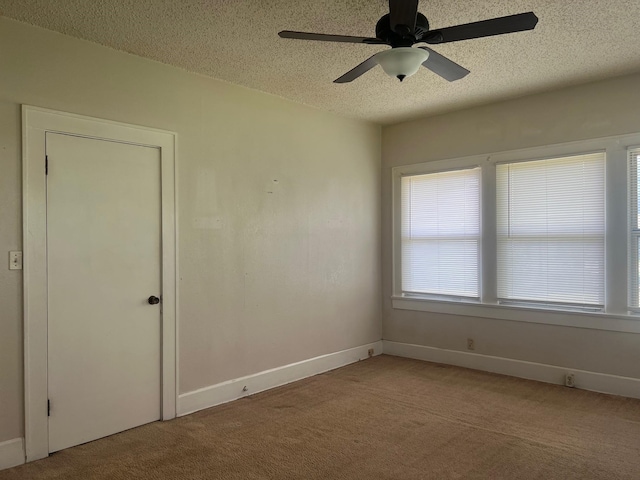 742 Elm St, Graham, TX 76450 - unfurnished room featuring light colored carpet, a textured ceiling, baseboards, and ceiling fan