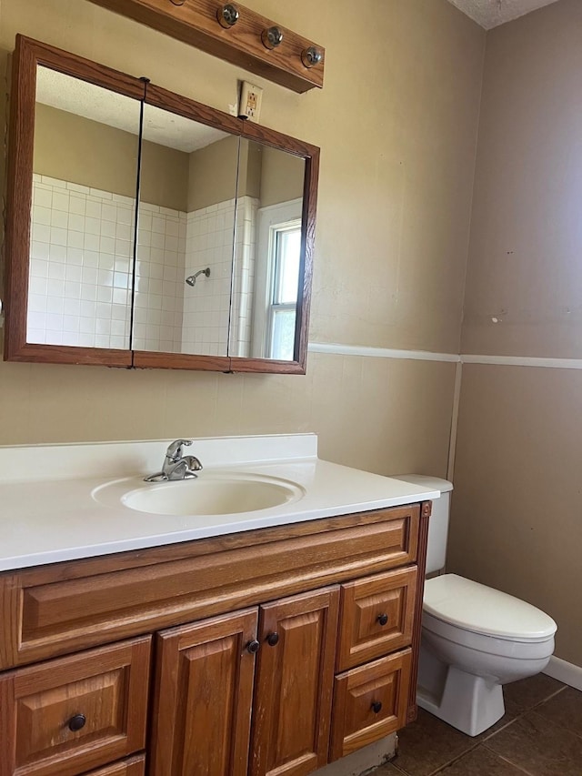 742 Elm St, Graham, TX 76450 - bathroom featuring toilet, tile patterned flooring, and vanity