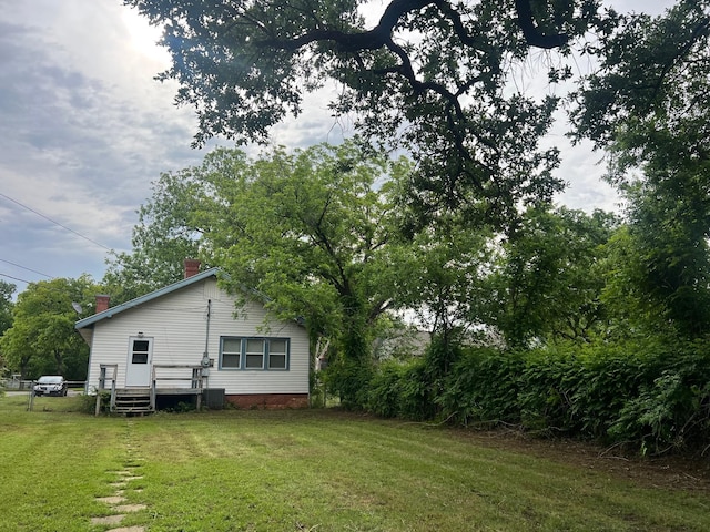 742 Elm St, Graham, TX 76450 - view of yard with central AC unit