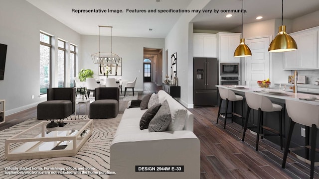 living room featuring baseboards, recessed lighting, dark wood-style floors, and a wealth of natural light