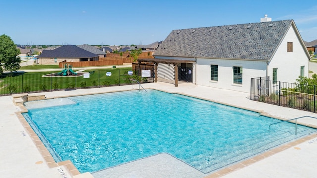 pool with fence, a patio, a lawn, and a residential view