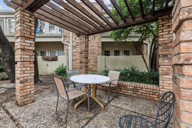 view of patio featuring outdoor dining area, a balcony, fence, and a pergola