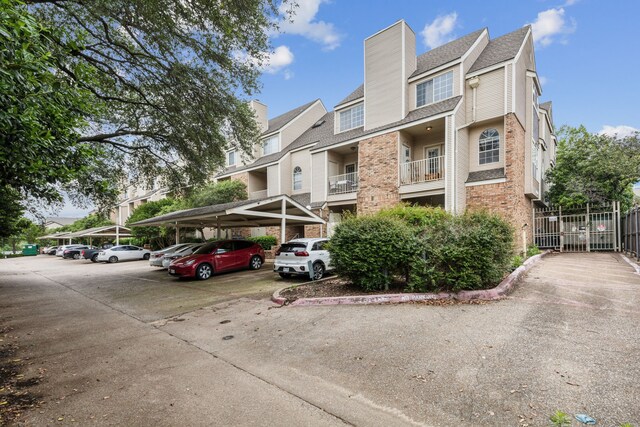 view of property featuring covered parking and fence