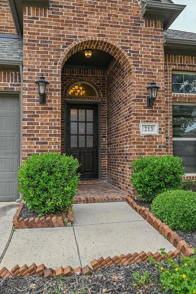 doorway to property with brick siding