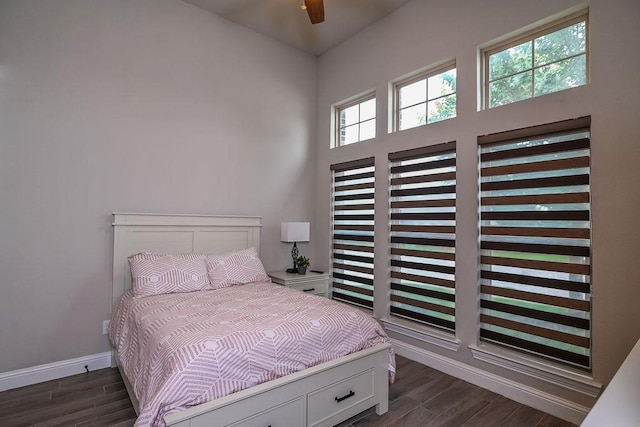 bedroom with baseboards and dark wood-style floors