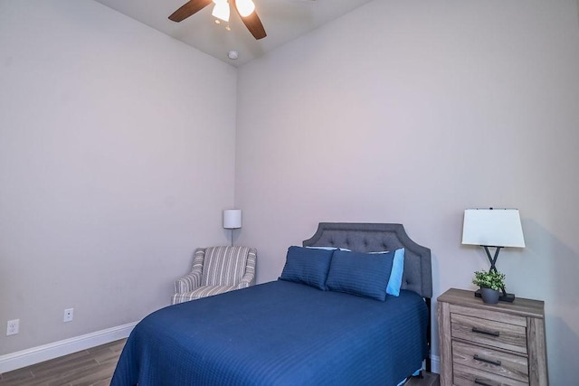 bedroom with baseboards, ceiling fan, and wood finished floors