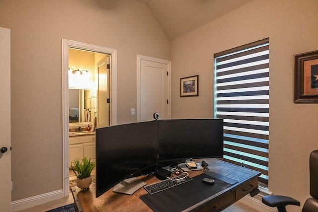 home office with baseboards, wood finished floors, and lofted ceiling