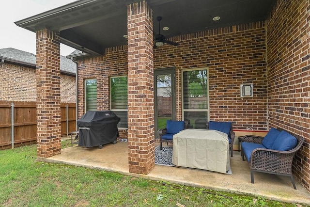 view of patio with grilling area, fence, and a ceiling fan