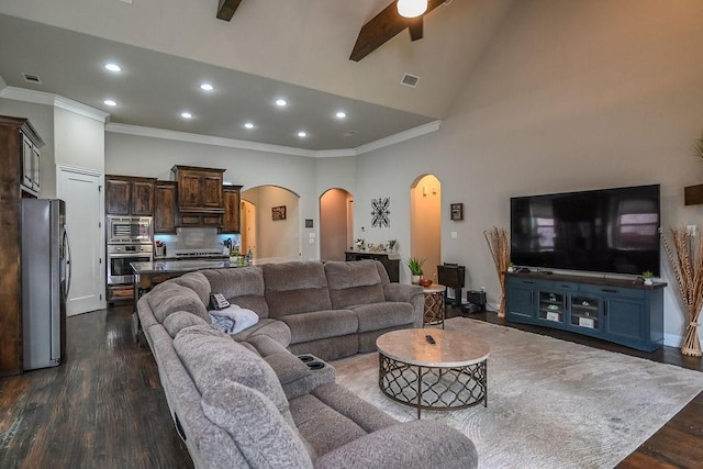 living room featuring crown molding, arched walkways, recessed lighting, and dark wood finished floors