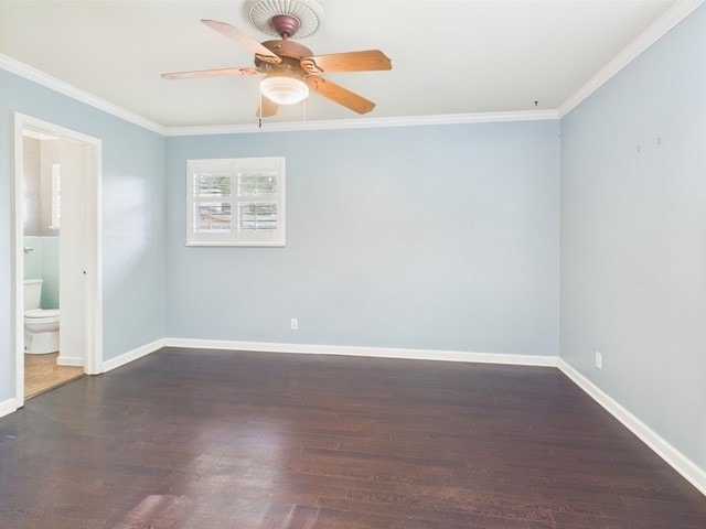 spare room with crown molding, ceiling fan, baseboards, and wood finished floors