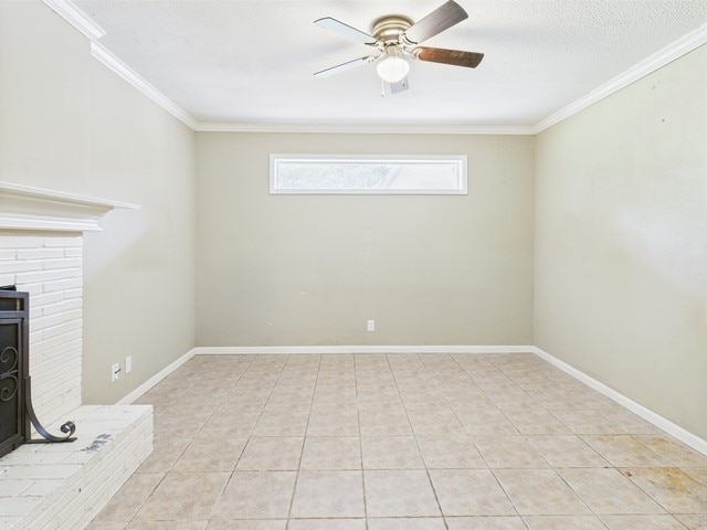unfurnished living room featuring light tile patterned floors, ornamental molding, a wood stove, and a ceiling fan