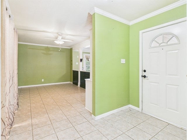 entryway featuring a ceiling fan, baseboards, ornamental molding, and light tile patterned floors