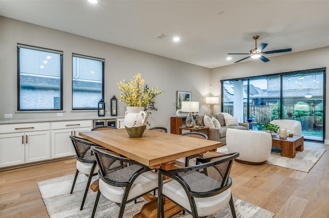 dining room with light wood-style floors, ceiling fan, recessed lighting, and visible vents
