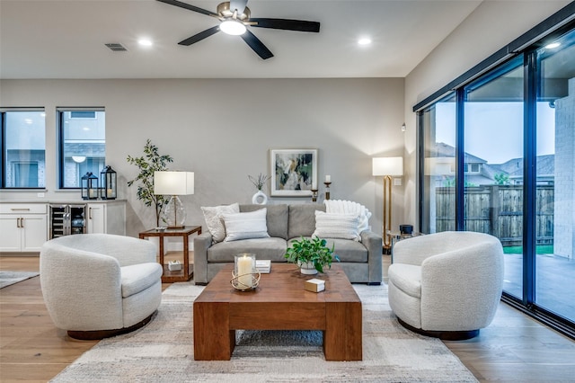 living area featuring visible vents, recessed lighting, light wood-style flooring, and wine cooler