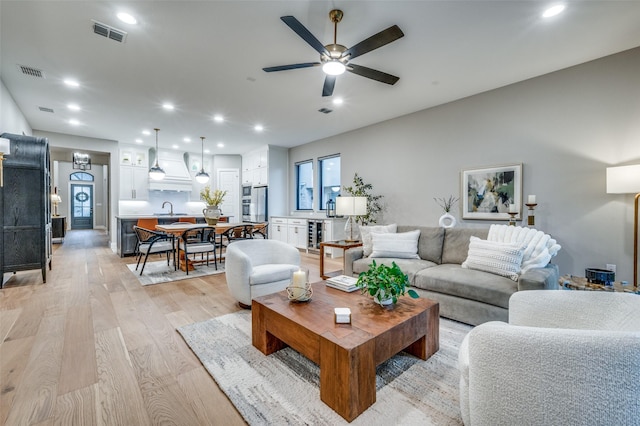 living area featuring visible vents, recessed lighting, and a ceiling fan