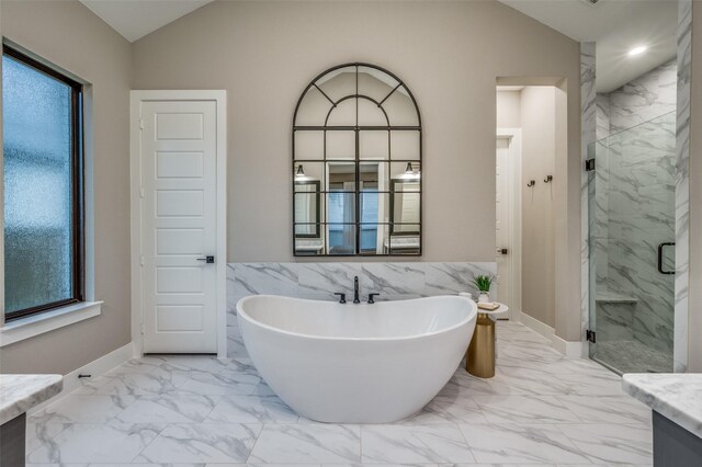 bathroom featuring a freestanding tub, a marble finish shower, vanity, and marble finish floor