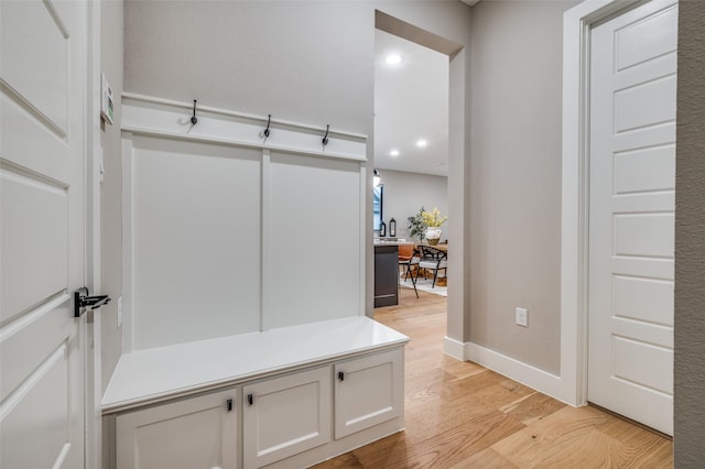 mudroom featuring light wood-type flooring, recessed lighting, and baseboards