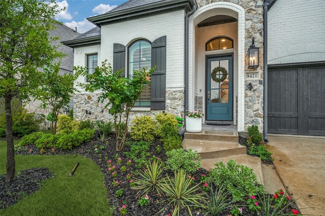 property entrance featuring brick siding and stone siding