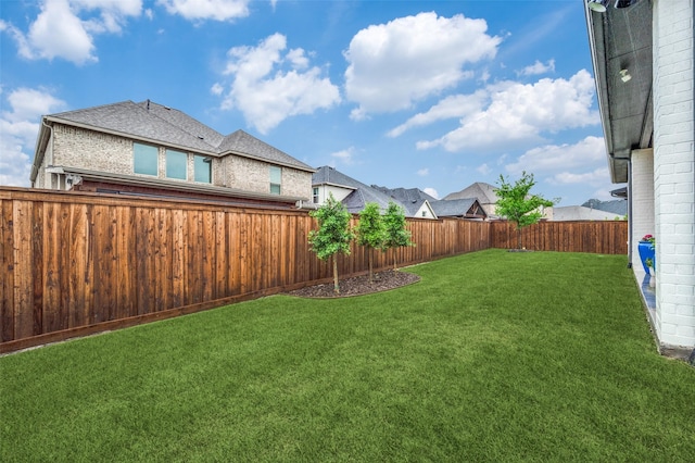view of yard with a fenced backyard