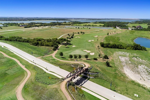 drone / aerial view with a water view and golf course view