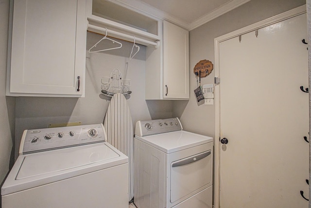 laundry area with crown molding, cabinet space, and washing machine and clothes dryer
